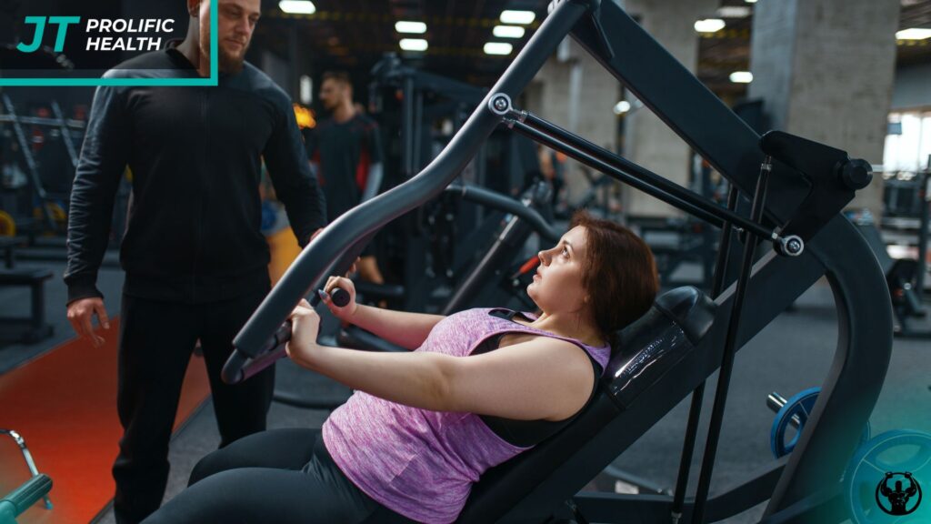 Woman engaging in personal training session using resistance machine, guided by trainer, in fitness center, emphasizing personalized coaching and movement analysis for strength assessment.